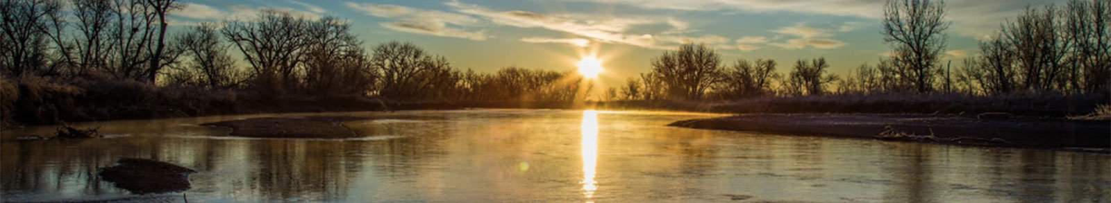 Sunset reflecting on the surface of a creek.